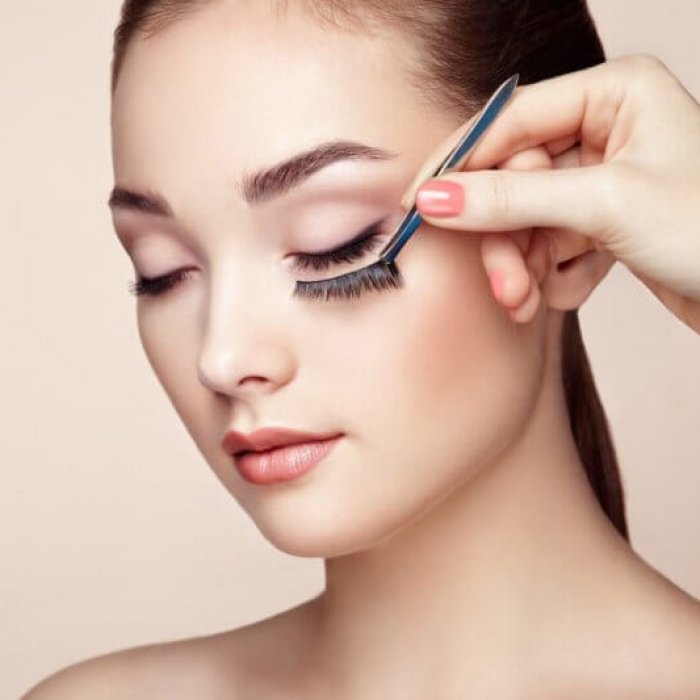 Makeup artist glues eyelashes